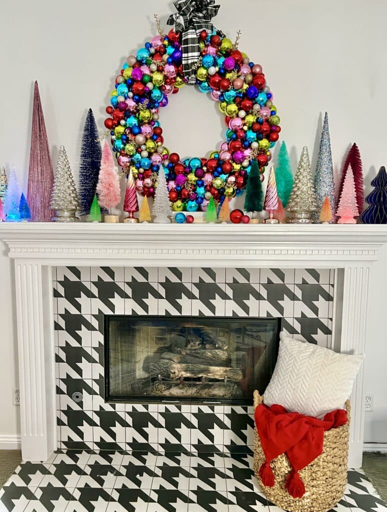 A Christmas Ornament Wreath above a fireplace mantel