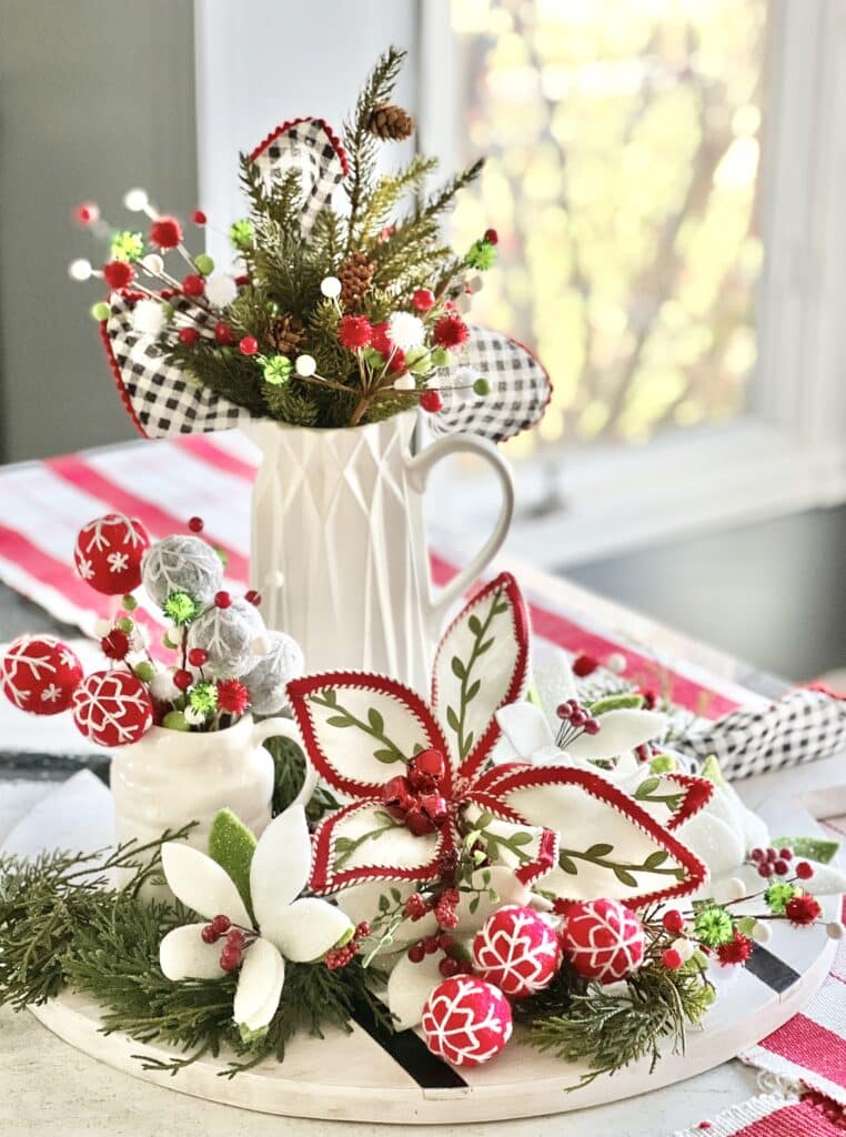 A charcuterie board filled with Christmas florals is a simple Christmas centerpiece idea.