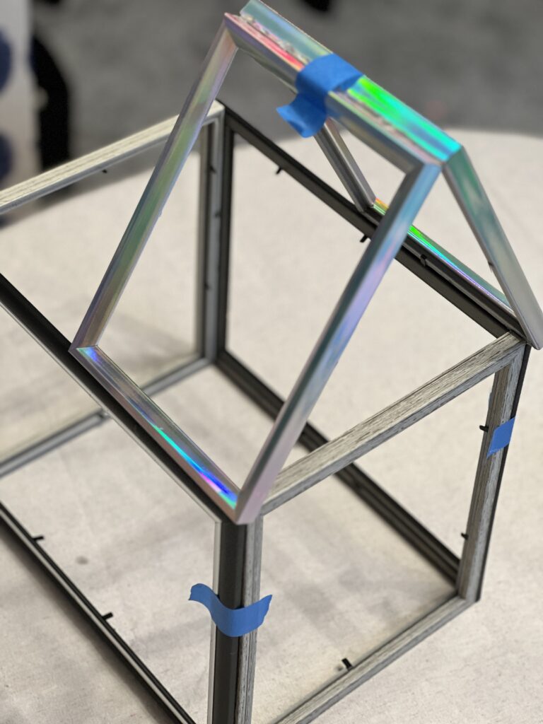 Smaller photo frames glued together at an angle to create the DIY tabletop greenhouse roof.