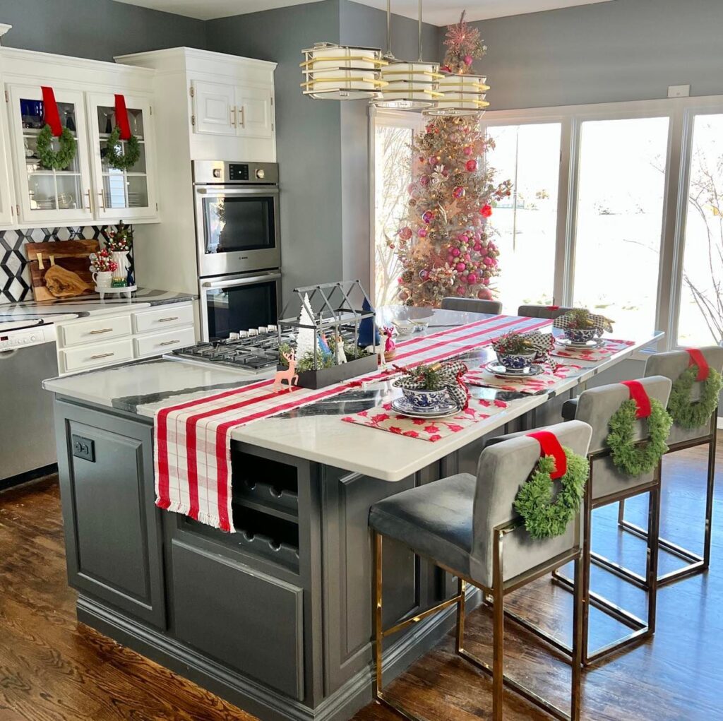 A kitchen island decorated for Christmas beside a Christmas tree is the first room you see on this colorful Christmas Home Tour.