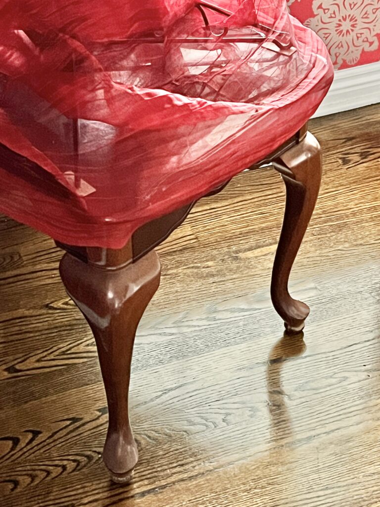 A coffee table draped with red fabric holds the inverted Christmas tree.