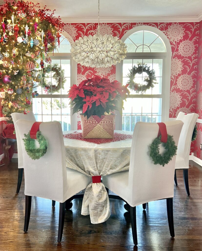 The dining room chairs decorated with wreaths.