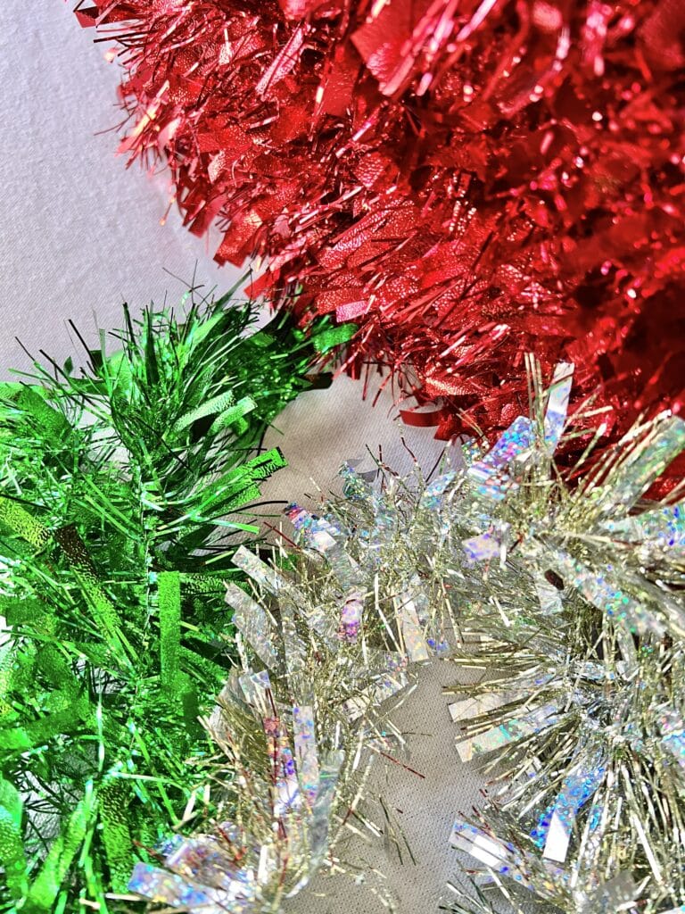 Red, green, silver, and gold tinsel garland.
