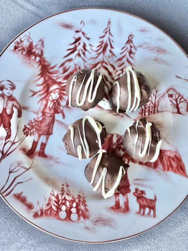 Chocolate dipped candy balls with drizzled vanilla almond bark.