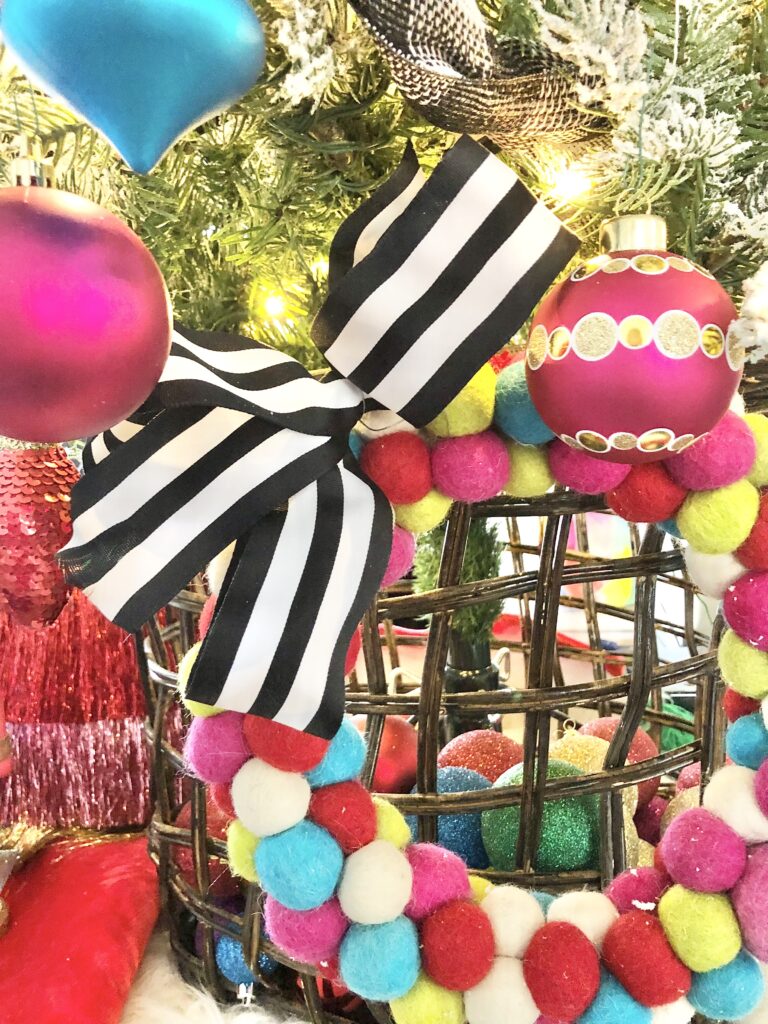 A colorful felted wool ball wreath on a basket