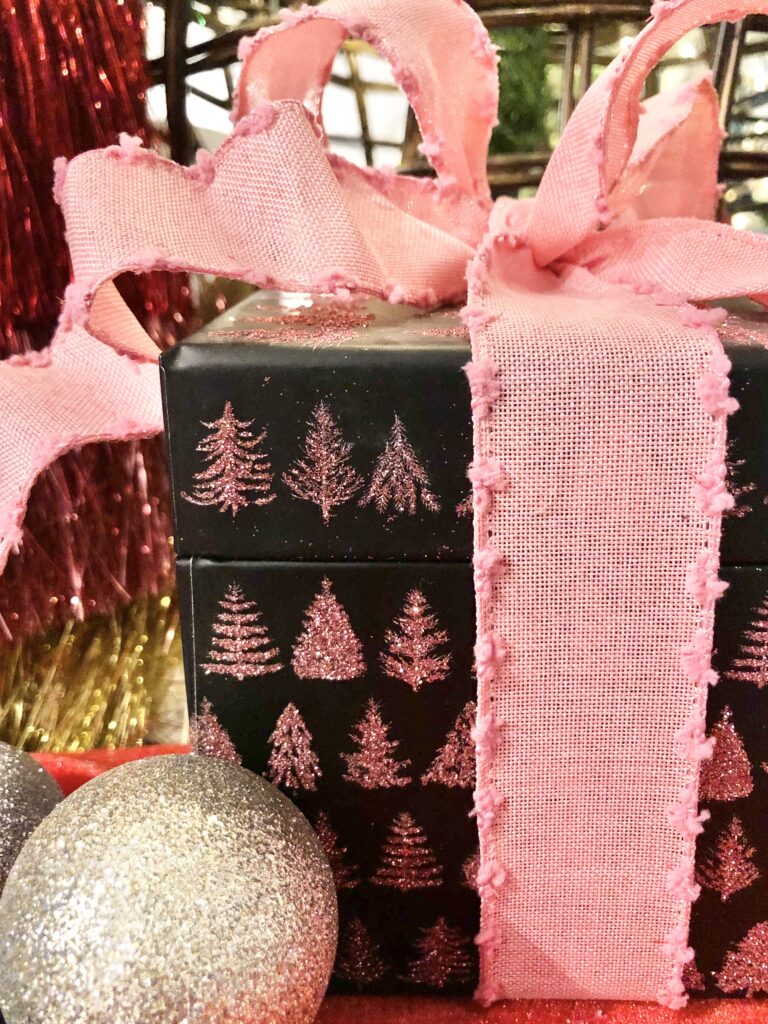 A pink bow on a black box.