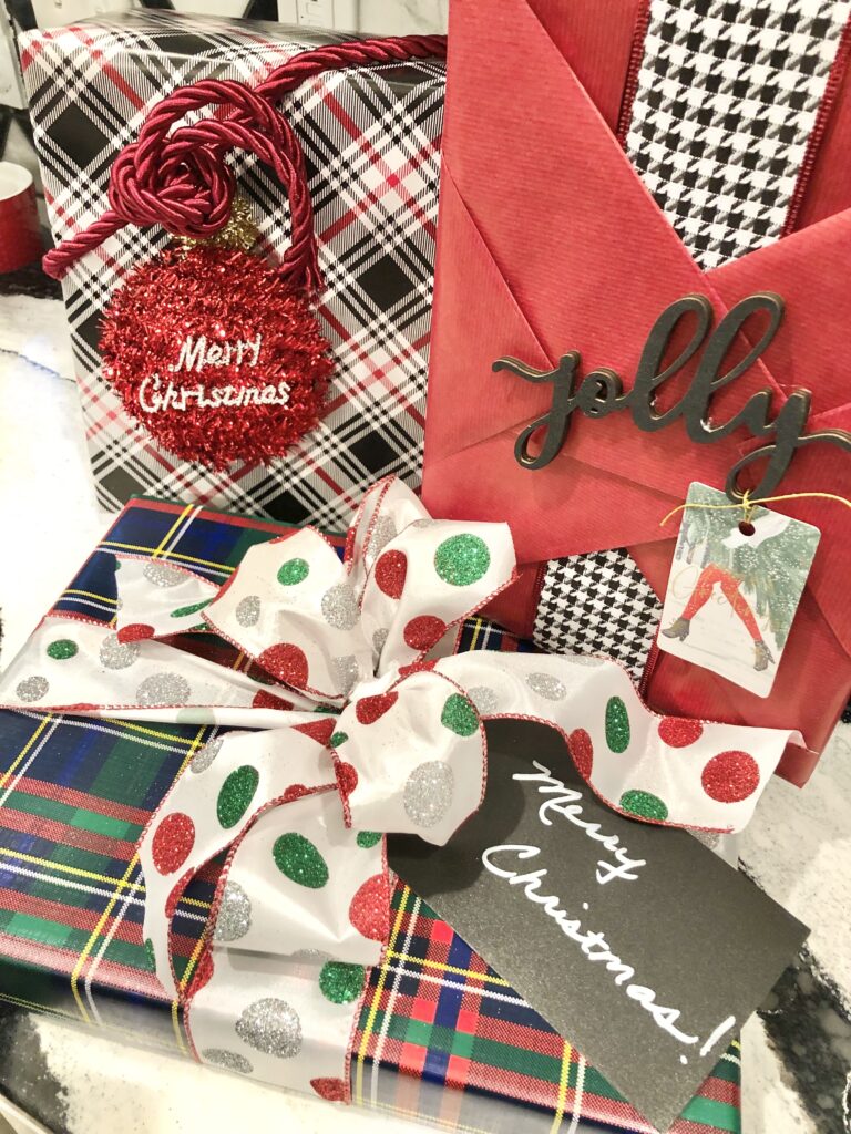 Several colorful Christmas gifts wrapped in various plaid papers.