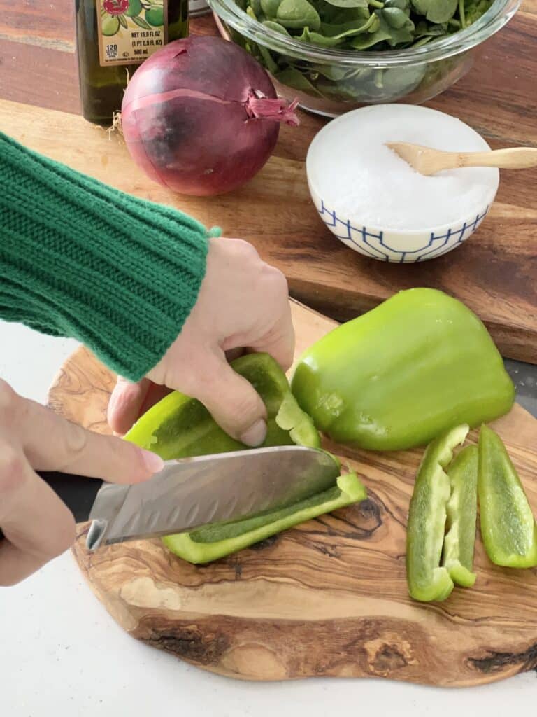 Chopping green peppers for this healthy winter vegetable soup.