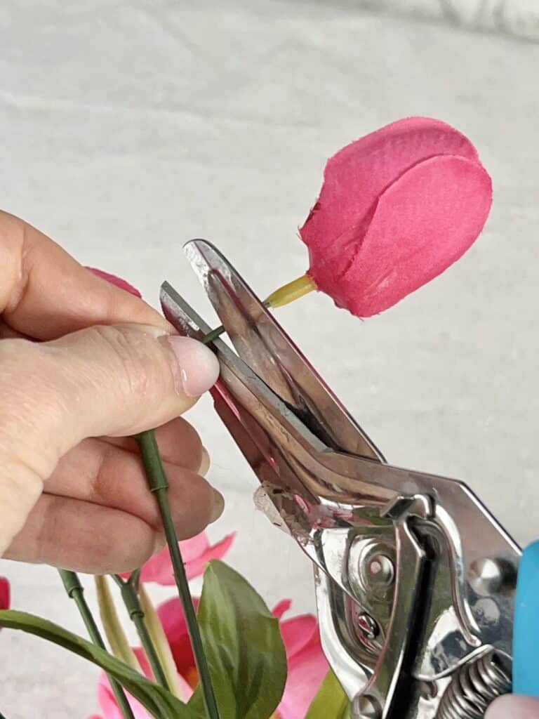 Cutting the faux flower off the stem.