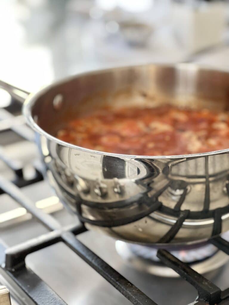 A pot of healthy winter soup simmering on the stovetop.