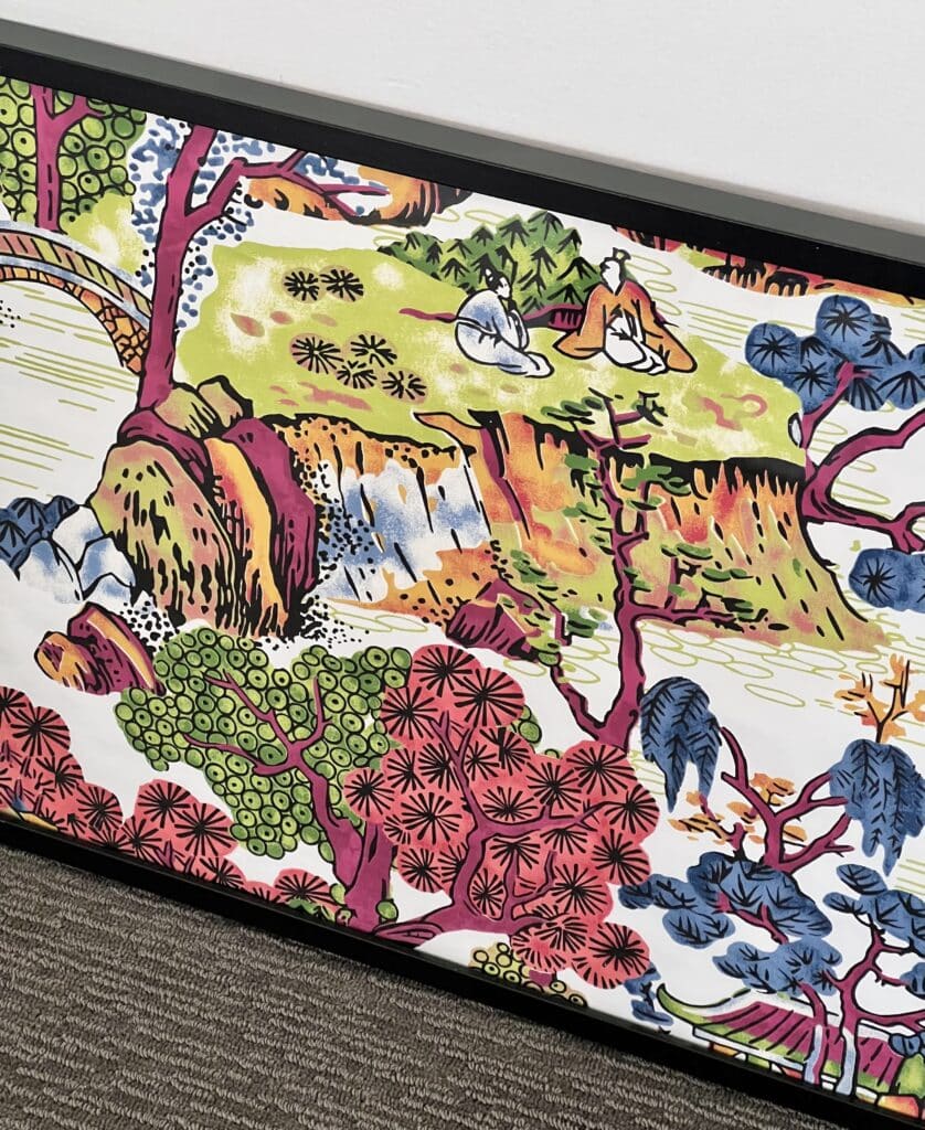 wallpaper crafts: A piece of chinoiserie wallpaper in a black frame.