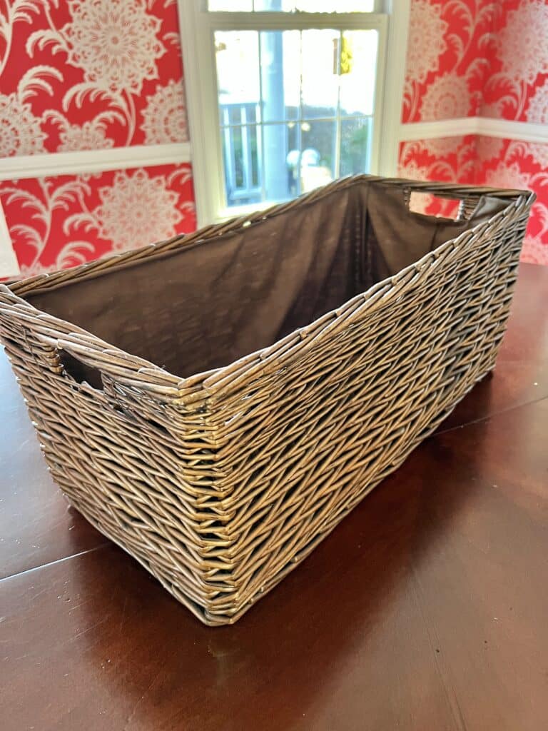 A wicker basket with a darker finish that will be transformed with paint.