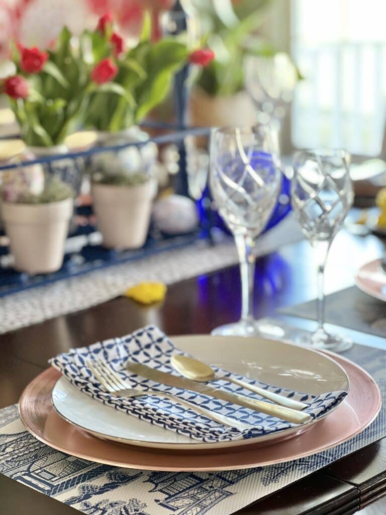 A light and airy table setting with glass goblets.