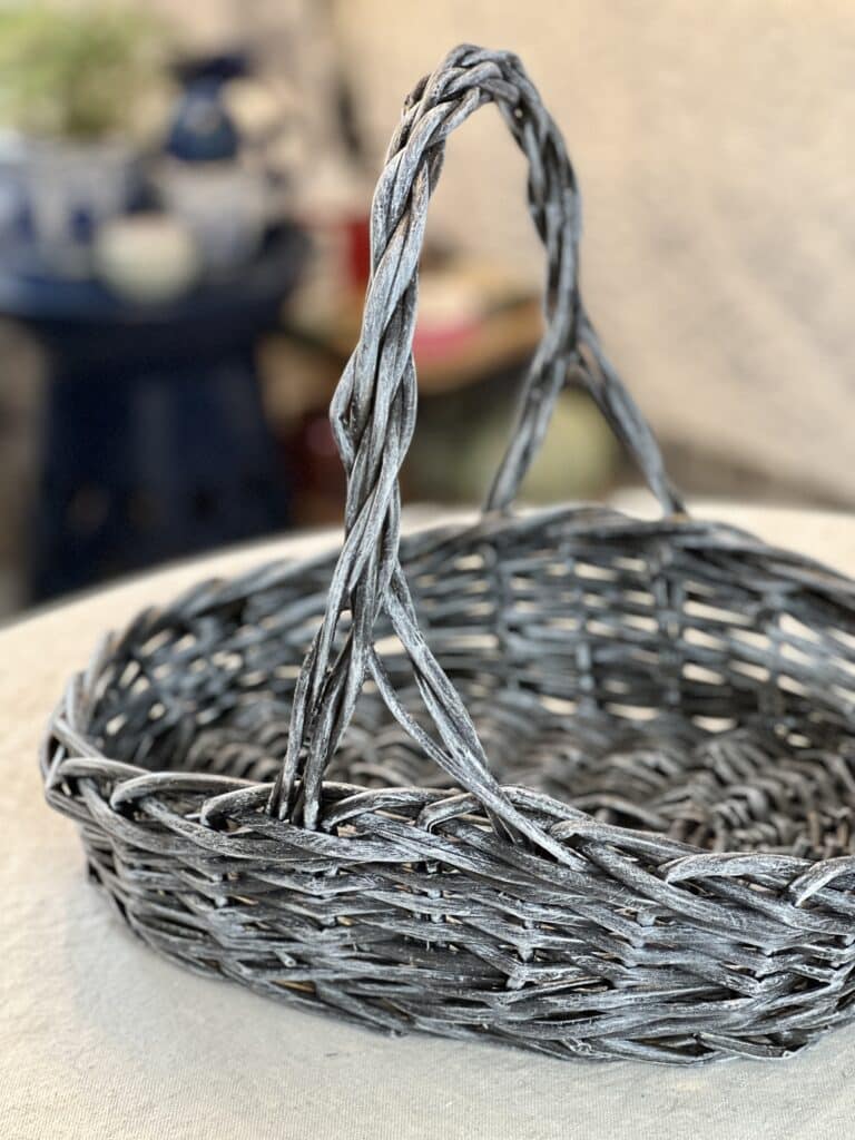 A painted wicker basket using a dry brush technique.