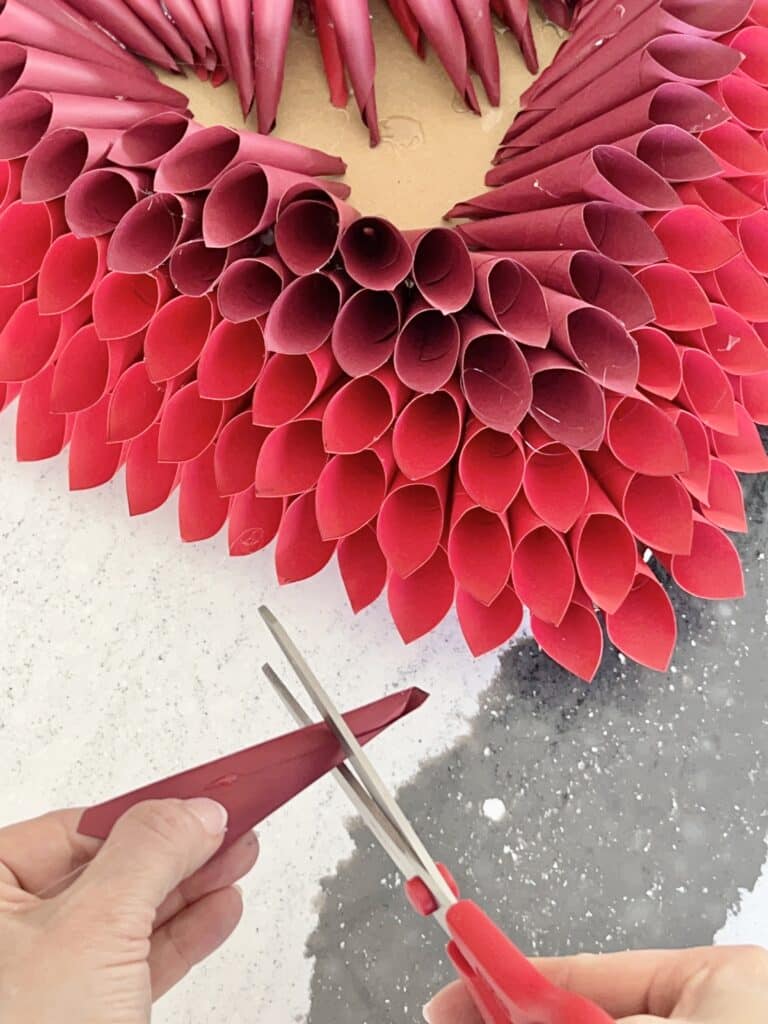 Two shades of red cones layered on the cardboard heart.