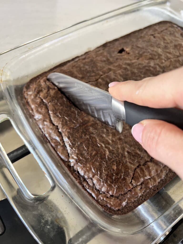 Cutting brownies into bite size pieces.