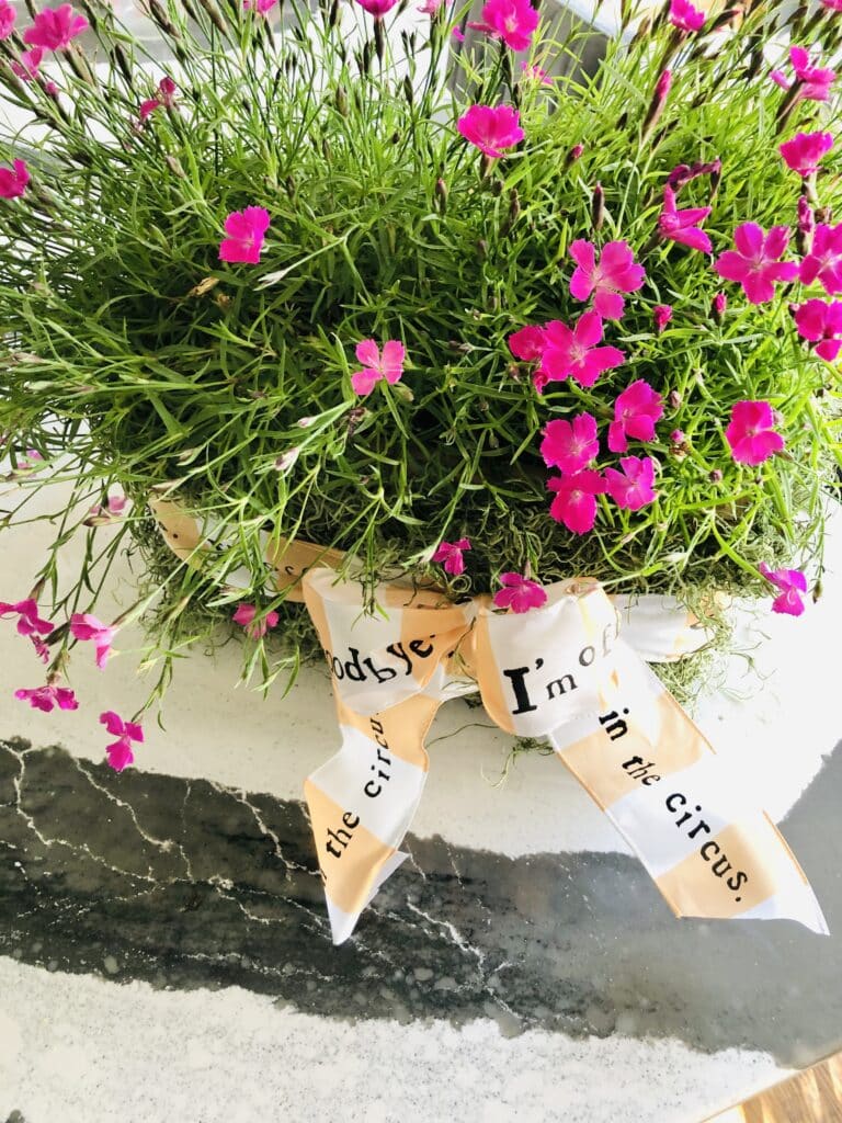 A May Day basket full of pink dianthus is a great kitchen island decor idea for spring.