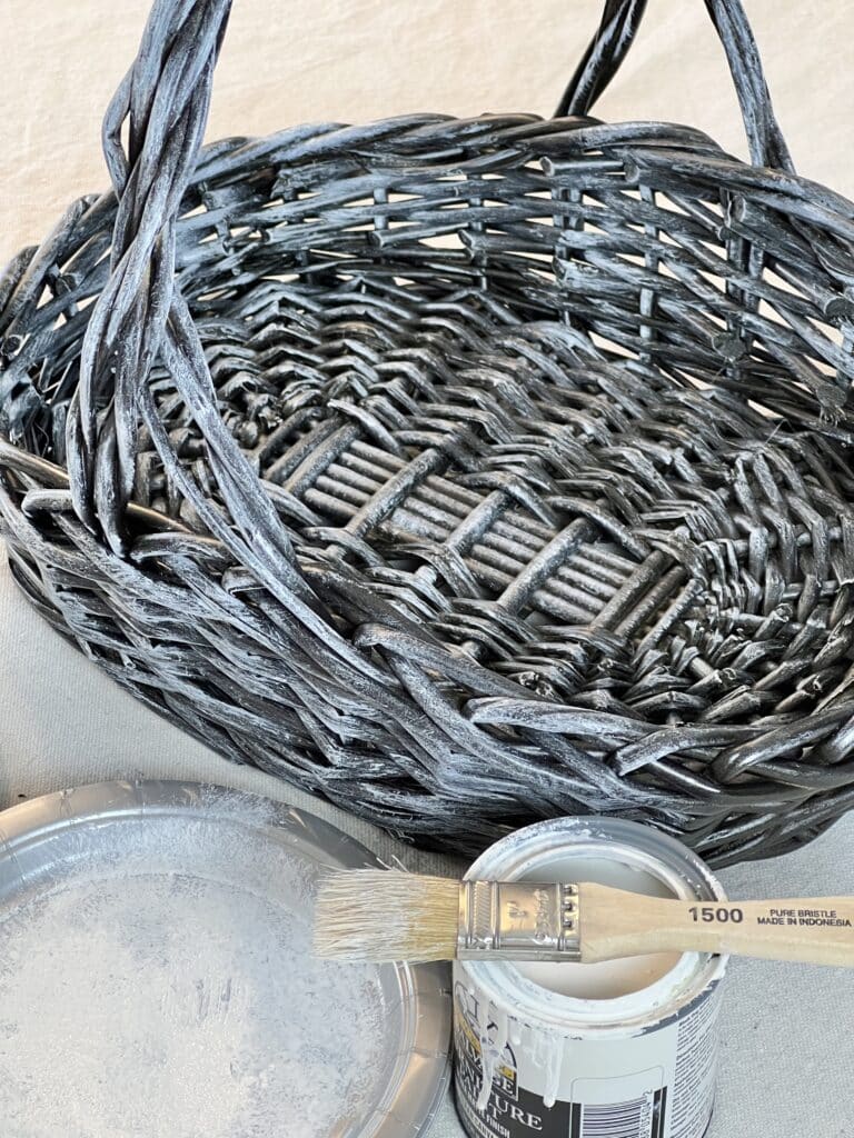 Dry brushing a spray painted wicker basket.
