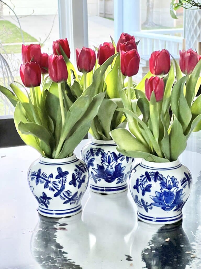 Kitchen island decor is easy to accomplish with flowers in small ceramic jars.