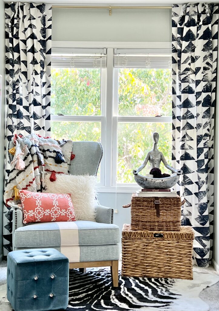 Reading nook ideas in a guest bedroom include layered textiles and pillows.