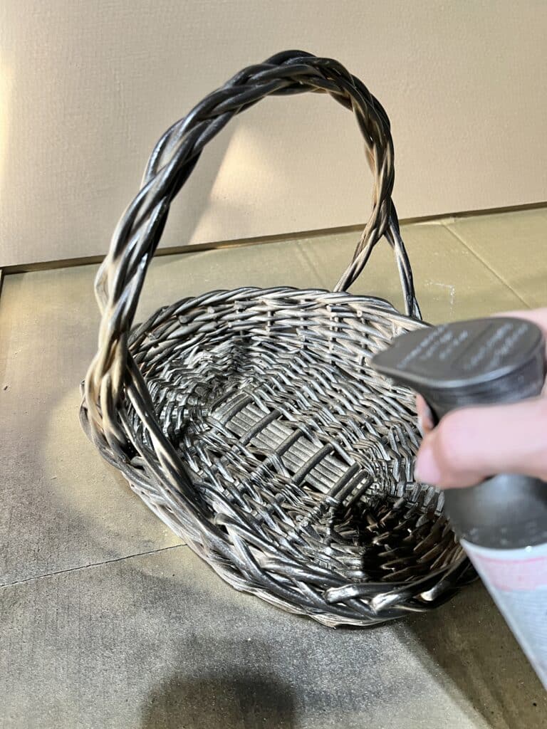 Spray painting a light colored wicker basket.