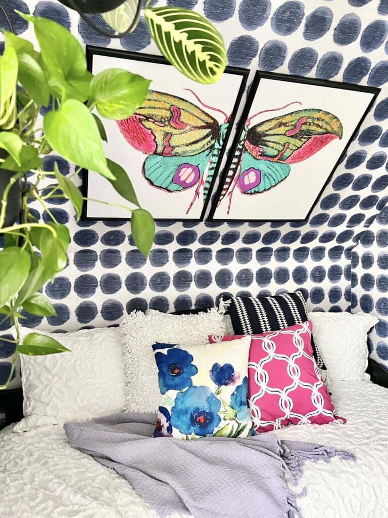 A colorful butterfly wall art piece hanging in a craft studio.