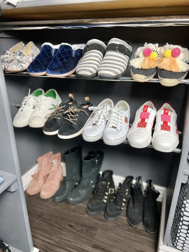 DIY tension rod shoe shelving with three different rows of shoes.