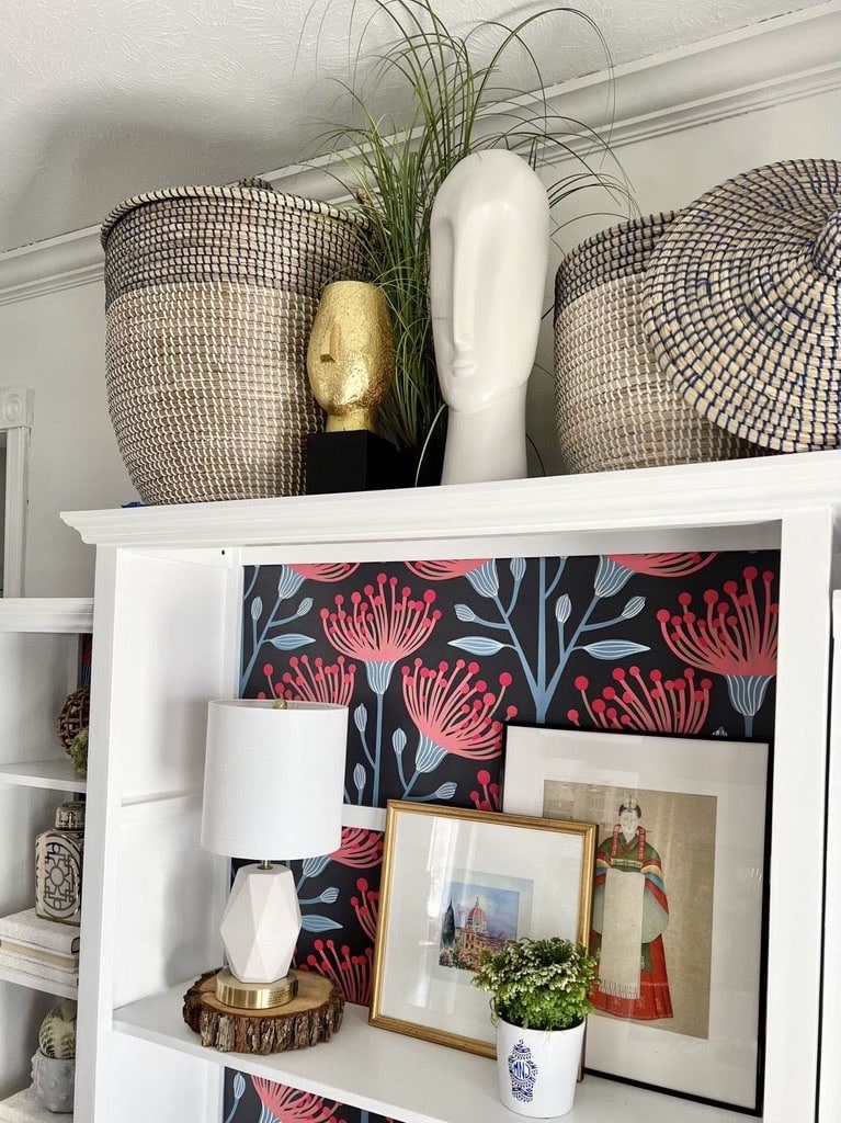 The top of the bookcase is accessorized with home accents after the makeover.