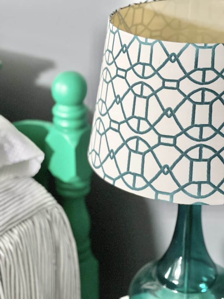 A teal and ivory patterned lamp shade.
