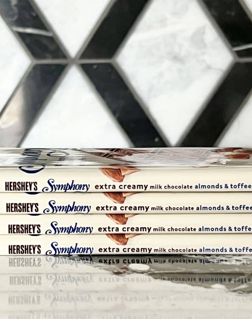 A stack of four Hershey's Symphony bars sitting on a kitchen countertop.