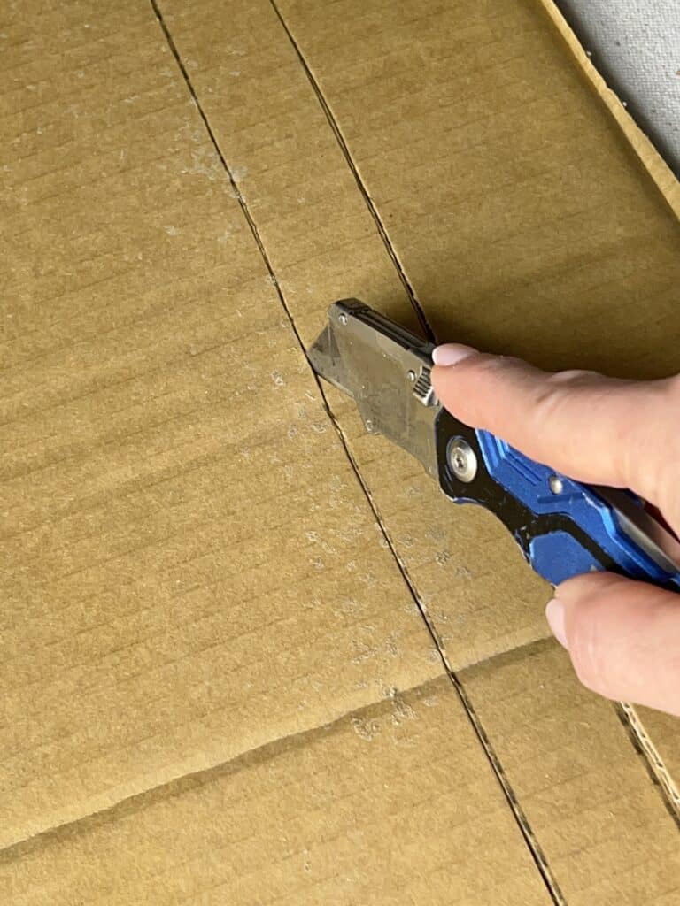 Scoring and cutting a cardboard strip.