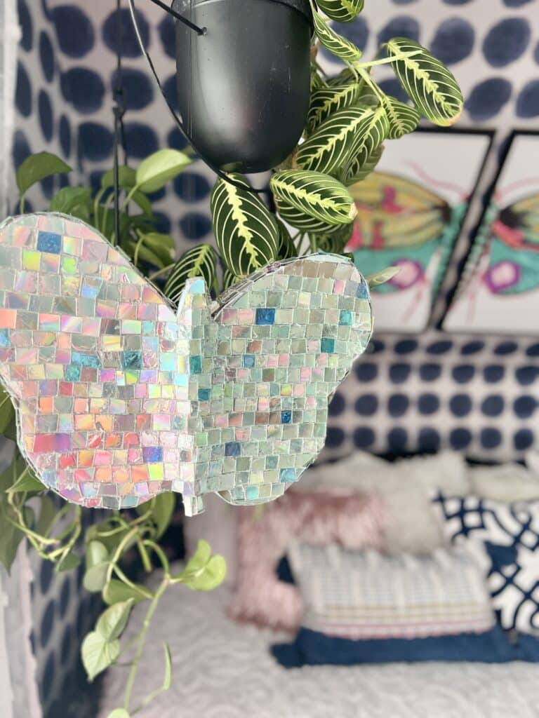 The outdoor hanging butterfly decor shown hanging indoors in a craft room.