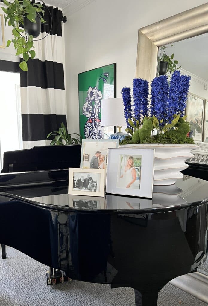 Family photographs sitting on a piano.