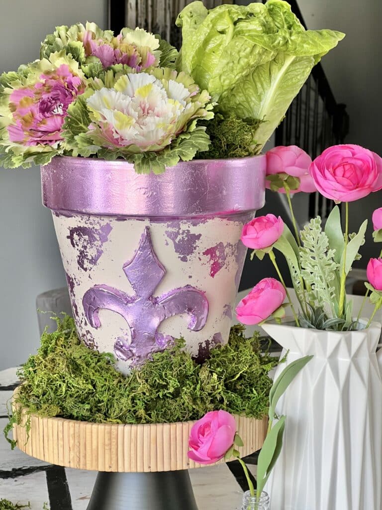 
A fleur de lis flower pot decorated with air dry clay.