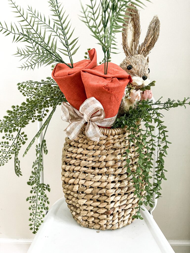An adorable door basket with a bunny and two carrots from Our Tiny Nest.