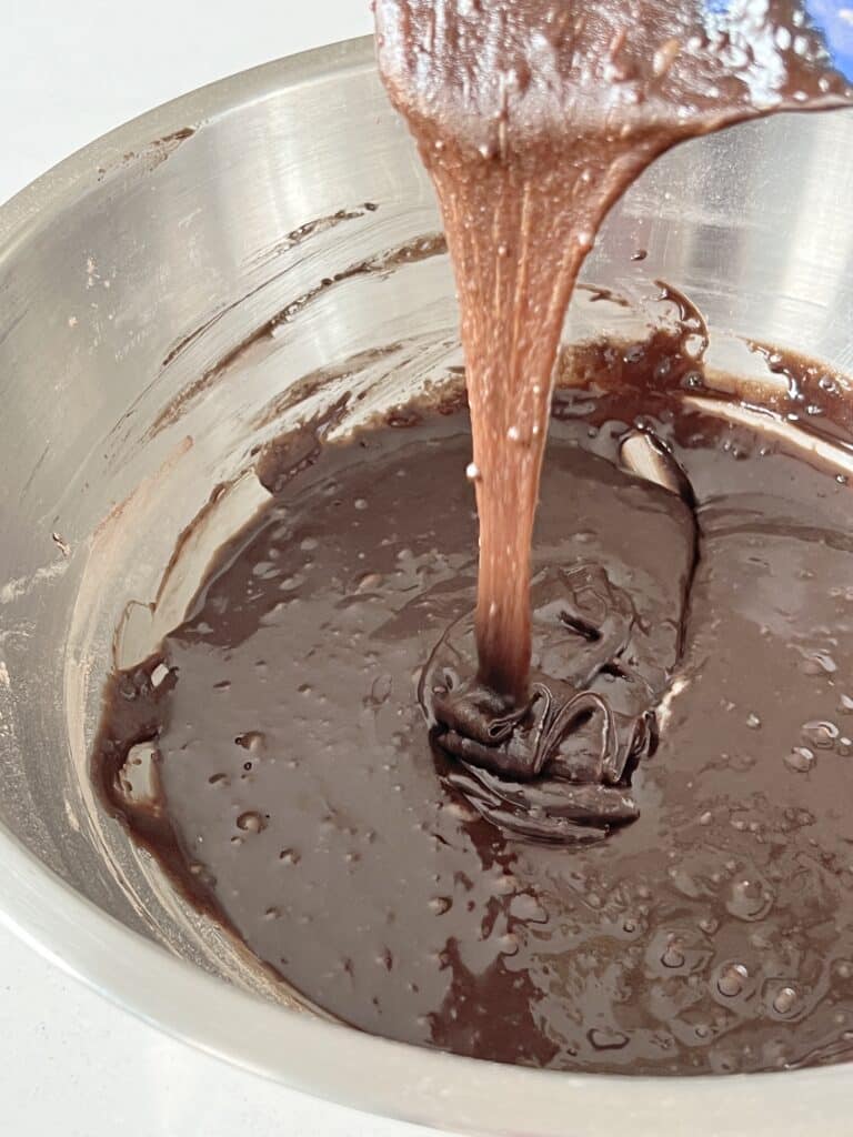 Mixing brownie batter with a spatula.