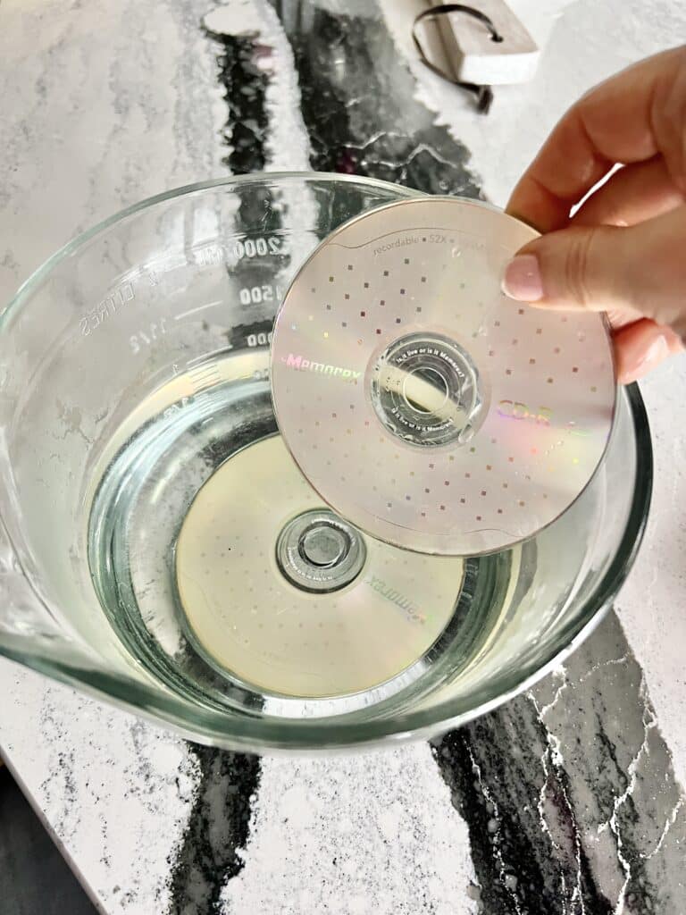 Soaking old CDs in warm water.