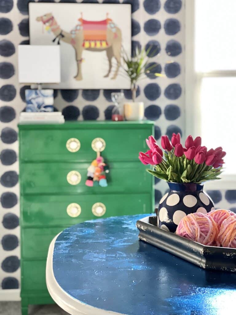 Red tulips on a blue table.