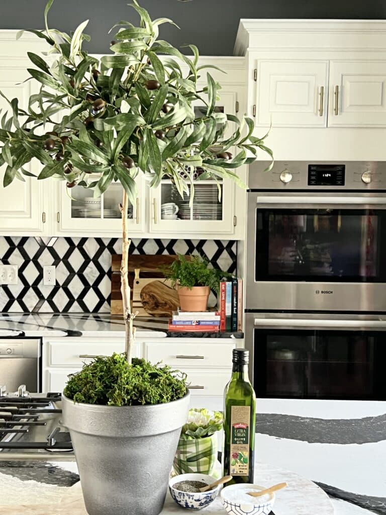 A DIY faux olive tree topiary displayed on the kitchen island.