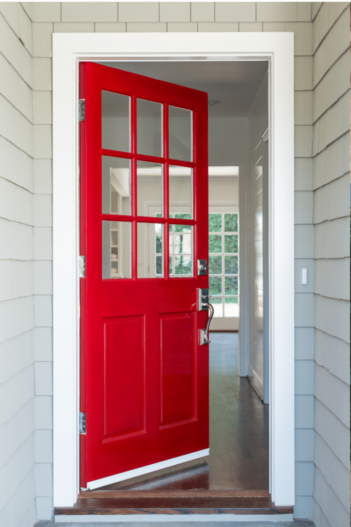 A red door opening into a home.