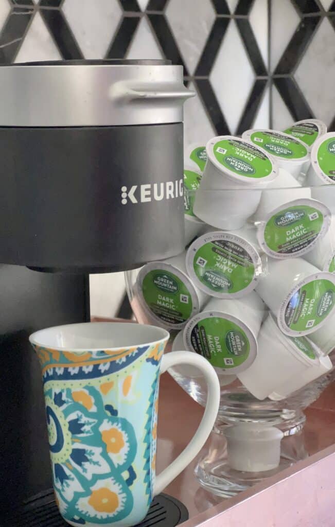Coffee pods stored in a glass vase for daily storage.