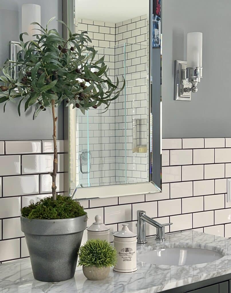 A DIY faux olive tree topiary in a bathroom.