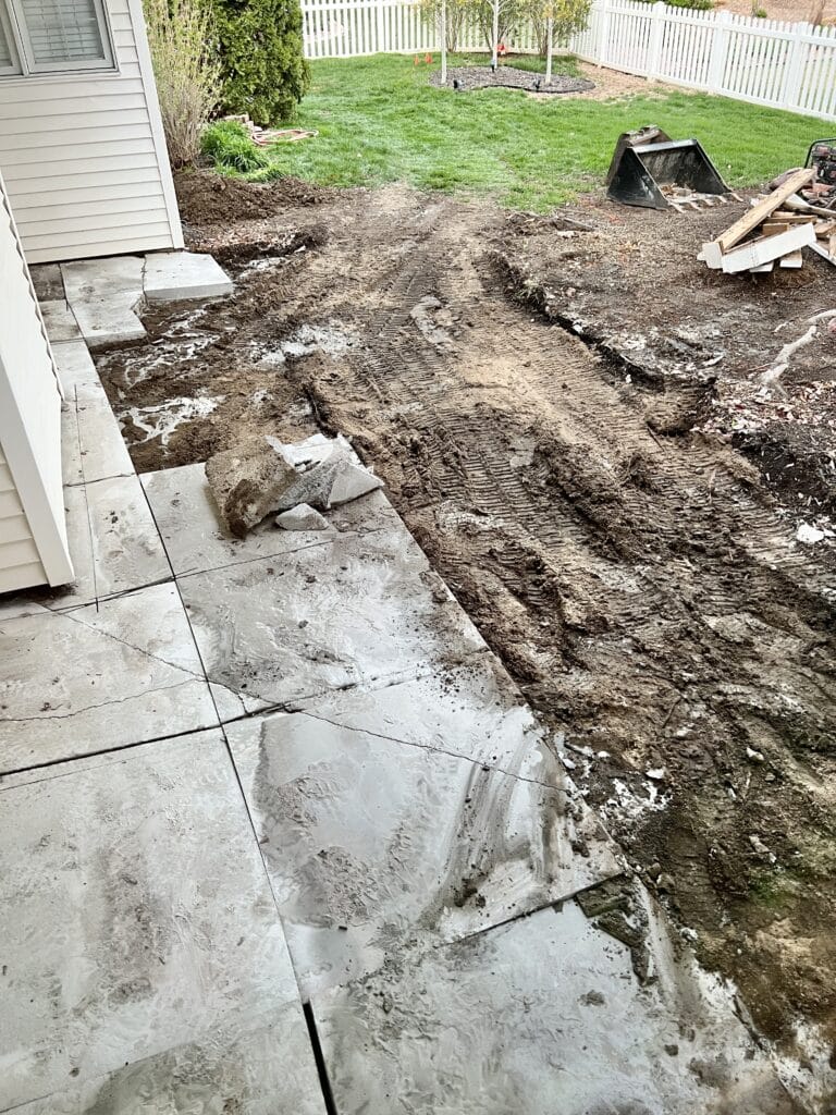 Digging up the patio concrete.