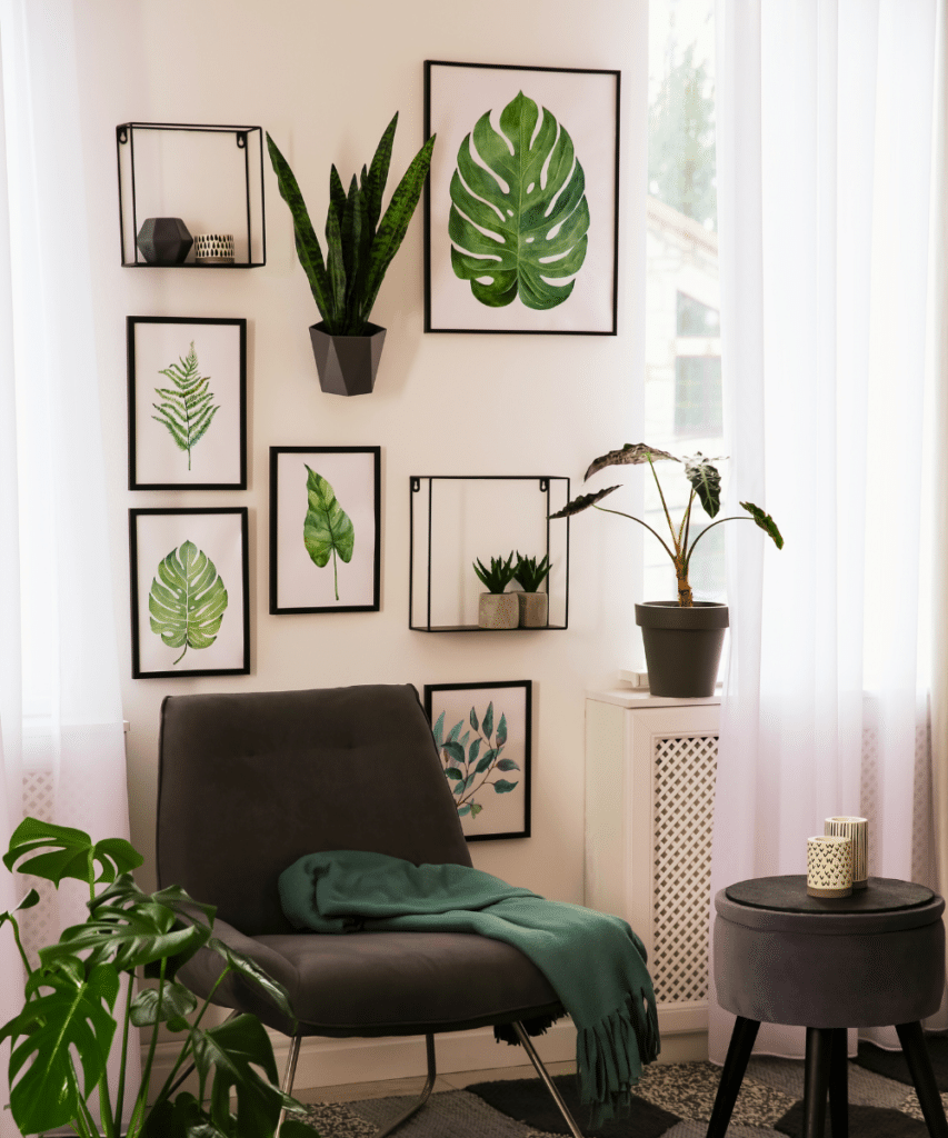 A gallery wall of green leaf artwork.