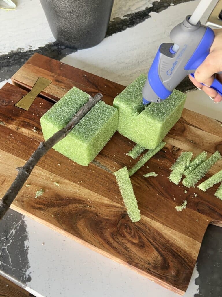 Glueing the branch into the first styrofoam foam.