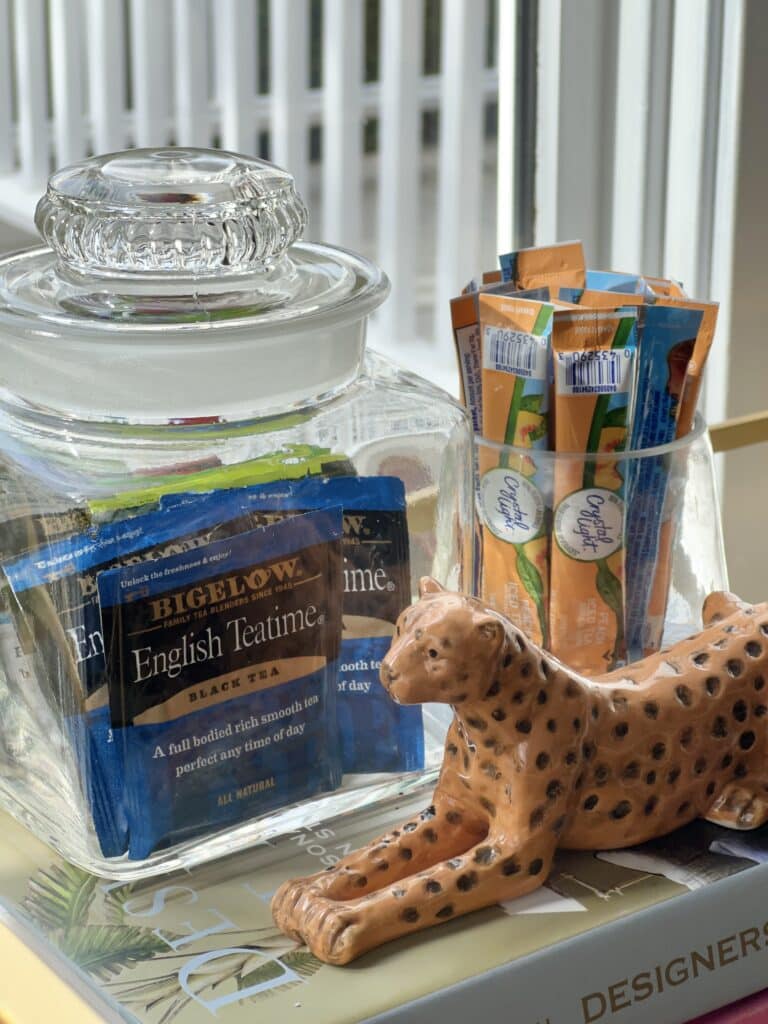 Glass containers holding tea bags and individual tea packets.