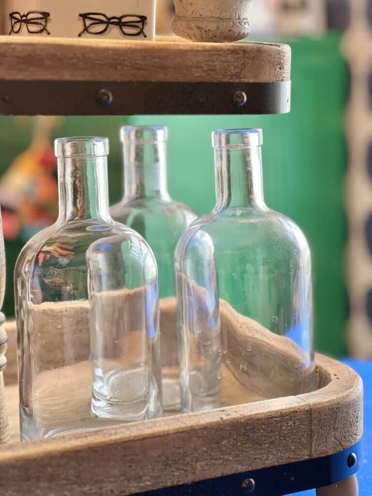 Three glass bottles on a tray.