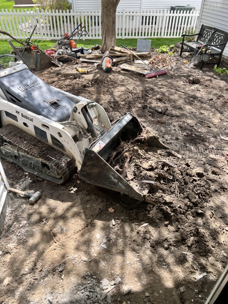 Leveling the dirt for the new patio pavers.