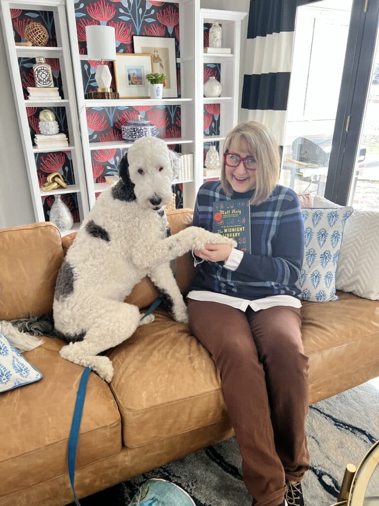 The dog with a paw on a book.