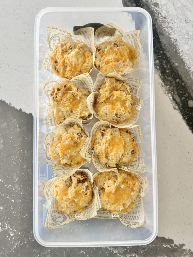 This sausage muffin recipe makes one dozen that can be stored in this lidded storage container.